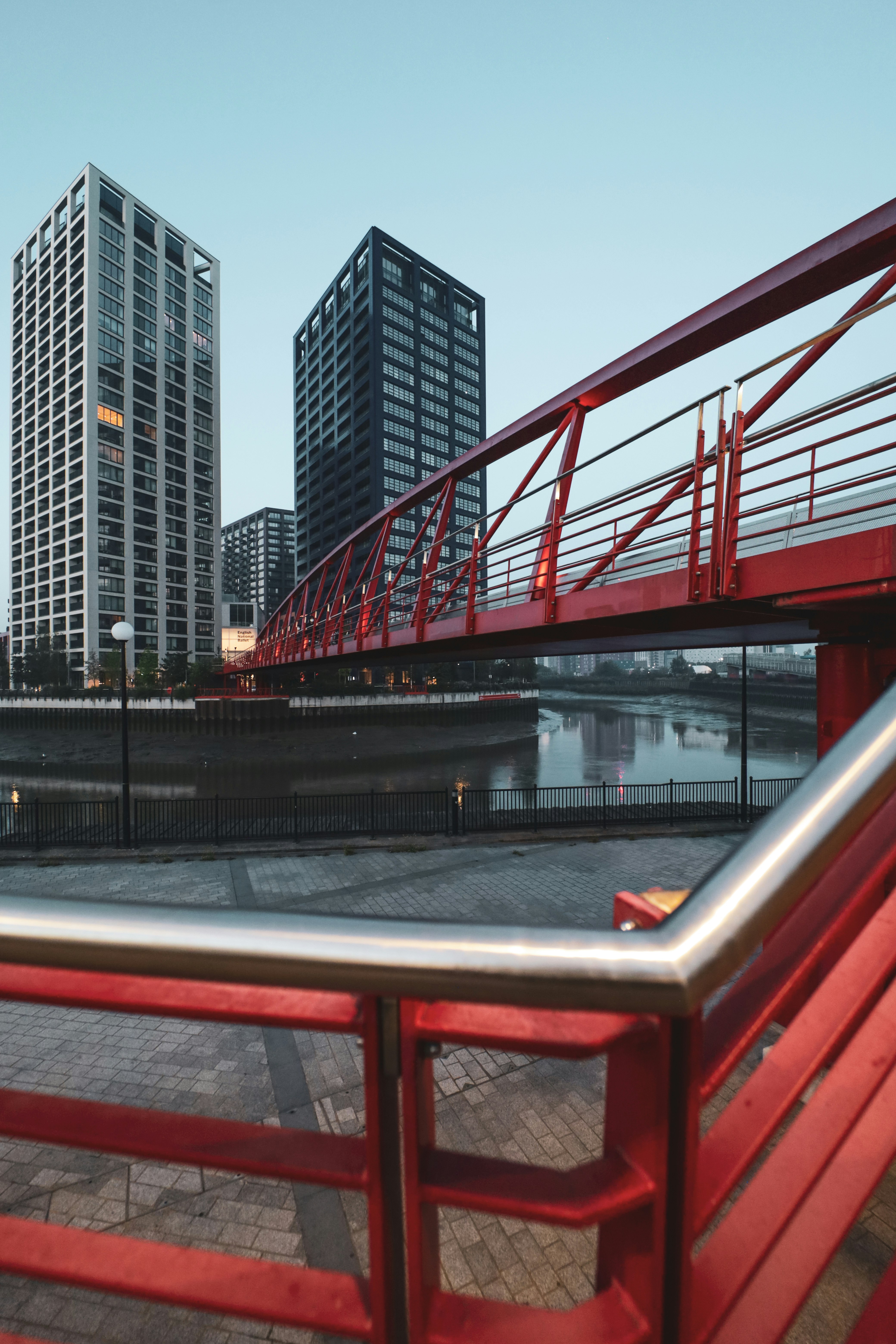 red metal railings near body of water during daytime